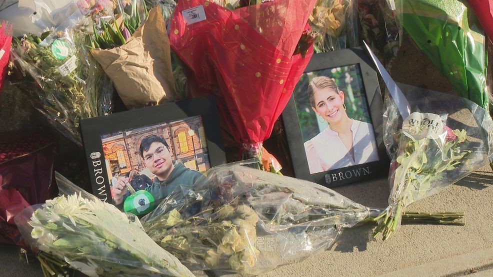 Flowers and pictures of the two students killed in the shooting. (WJAR)