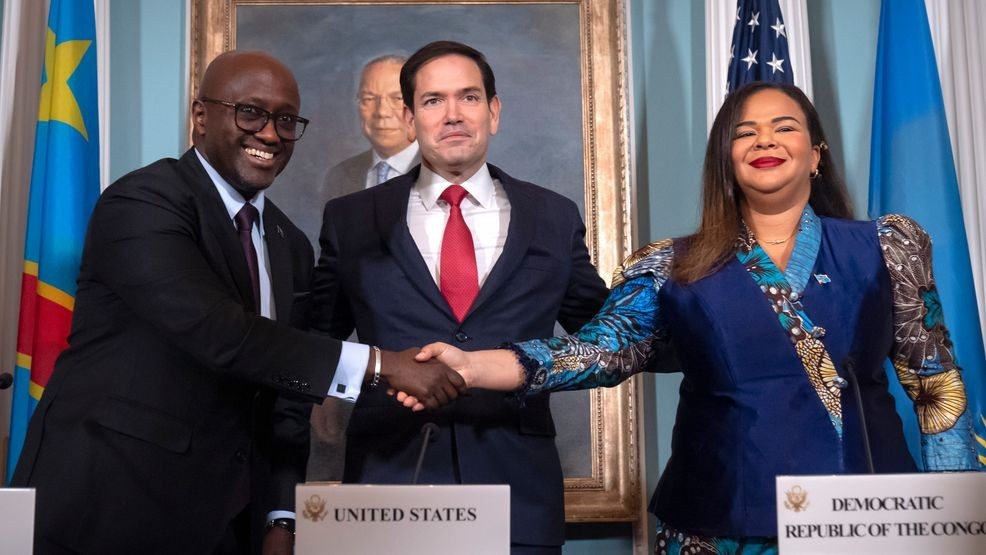 Secretary of State Marco Rubio, center, stands with Rwanda's Foreign Minister Olivier Nduhungirehe, left, and Democratic Republic of the Congo's Foreign Minister Therese Kayikwamba Wagner, right, as they shake hands after signing a peace agreement at the State Department, Friday, June 27, 2025, in Washington. (AP Photo/Mark Schiefelbein).