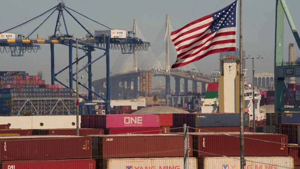 FILE - Containers with Yang Ming Marine Transport Corporation, a Taiwanese container shipping company, are stacked up at the Port of Los Angeles with the the Long Beach International Gateway Bridge seen in the background on Wednesday, April 9, 2025 in Los Angeles. (AP Photo/Damian Dovarganes, File)