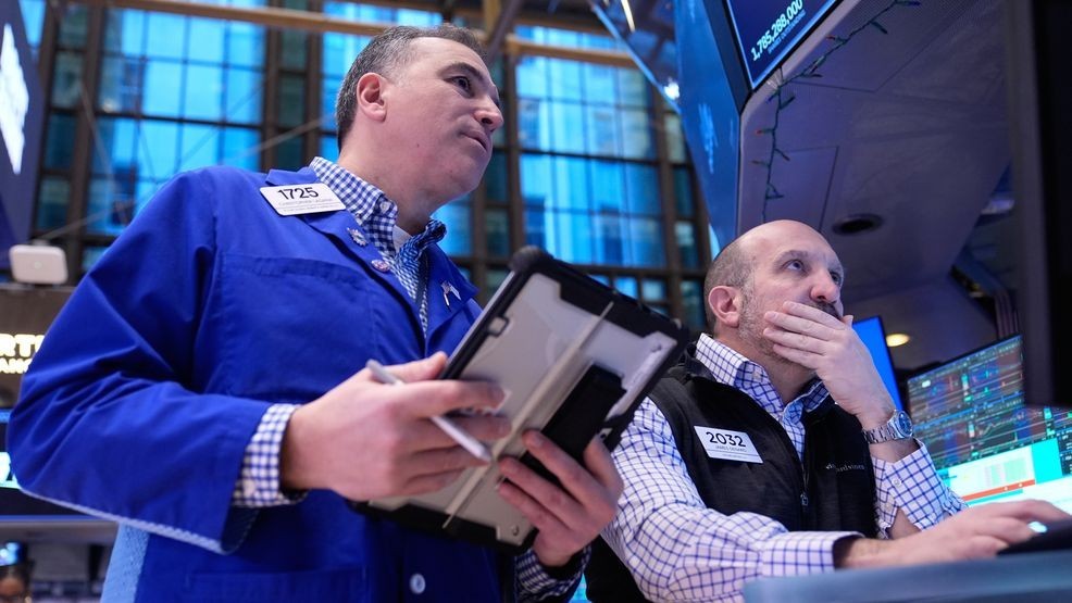 Christopher Lagana and James Denaro work on the floor at the New York Stock Exchange in New York, Friday, Jan. 9, 2026. (AP Photo/Seth Wenig)