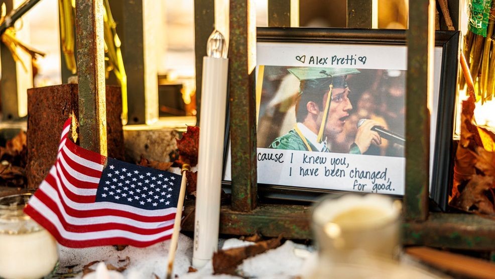 A framed photograph of Alex Pretti, along with candles and an American flag, sits at a memorial outside the Minneapolis VA hospital on Tuesday, Jan. 27, 2026, in Minneapolis. (Kerem Yücel/Minnesota Public Radio via AP)