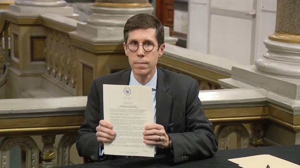 Mayor Brett Smiley signs an executive order bars ICE activities on city properties. (WJAR){ }