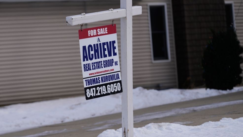 A "For Sale" sign is displayed in front of a home in Prospect Heights, Ill., Monday, Dec. 15, 2025. (AP Photo/Nam Y. Huh)