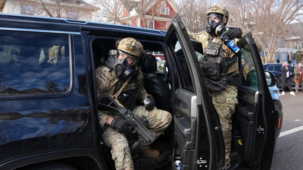 Federal agents get ready to disperse tear gas into a crowd at a protest, Monday, Jan. 12, 2026 in Minneapolis (AP Photo/Adam Gray)