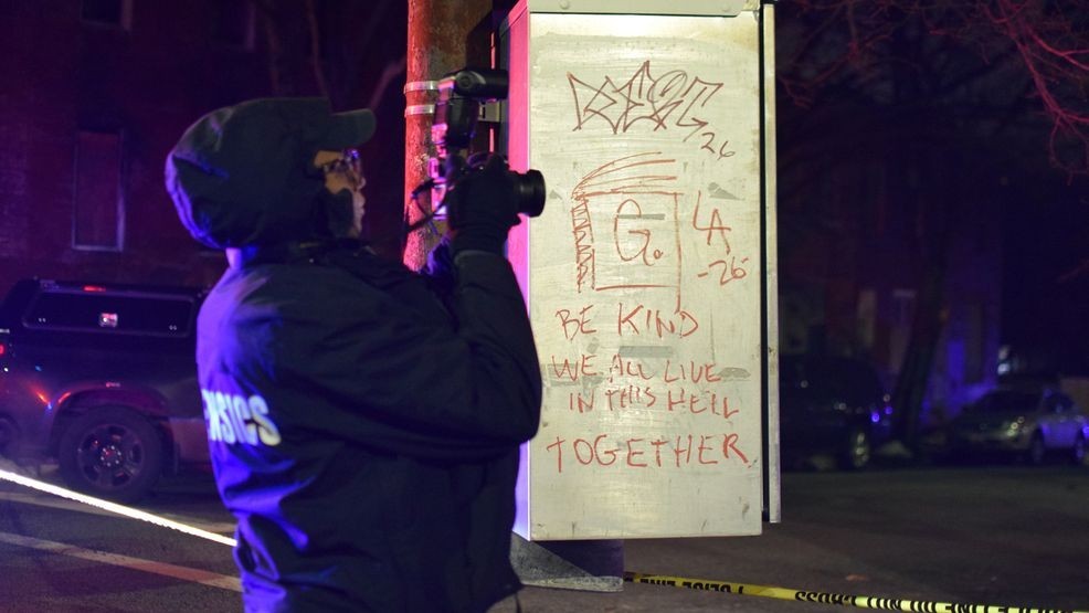 A crime lab technician takes pictures of the site of a shooting in west Baltimore on Wednesday. (WBFF / Maggie Ybarra){p}{/p}