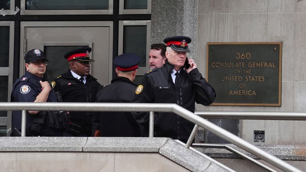 Toronto police officers investigate outside the U.S. consulate in Toronto on Tuesday March 10, 2026. (Frank Gunn/The Canadian Press via AP)