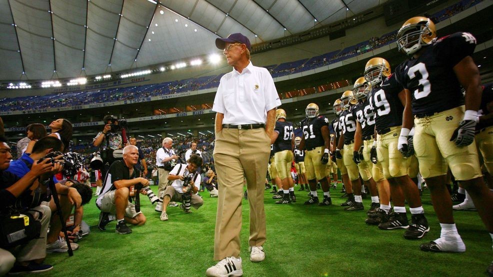 FILE - Notre Dame football coach Lou Holtz and his team players await before the start of their game against Japan's national American football team at the Notre Dame Japan Bowl in Tokyo, Saturday, July 25, 2009. (AP Photo/Junji Kurokawa, File)