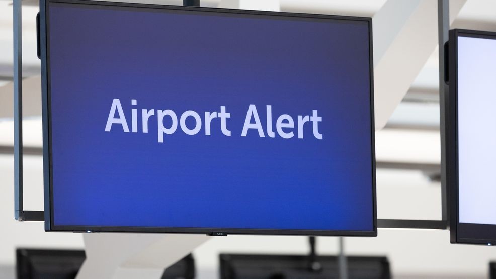 HOUSTON, TEXAS - MARCH 19: An airport alert is shown as travelers wait in line at Terminal E at George Bush International Airport on March 19, 2026 in Houston, Texas. Airports across the country continue to experience long lines during the federal shutdown affecting TSA. (Photo by Antranik Tavitian/Getty Images)