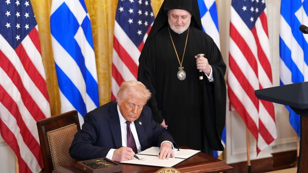FILE - President Donald Trump signs a proclamation for Greek Independence Day alongside Archbishop Elpidophoros of the Greek Orthodox Archdiocese of America during a Greek Independence Day celebration at the White House on March 24, 2025 in Washington. (Photo by Win McNamee/Getty Images)
