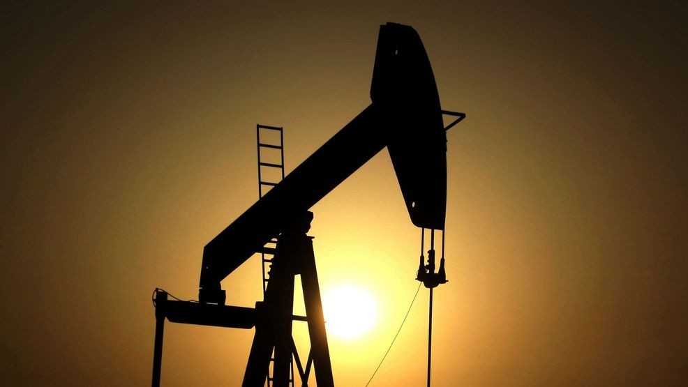 In this Wednesday, June 8, 2011 file photo, sun sets behind an oil pump in the desert oil fields of Sakhir, Bahrain. (AP Photo/Hasan Jamali, File)