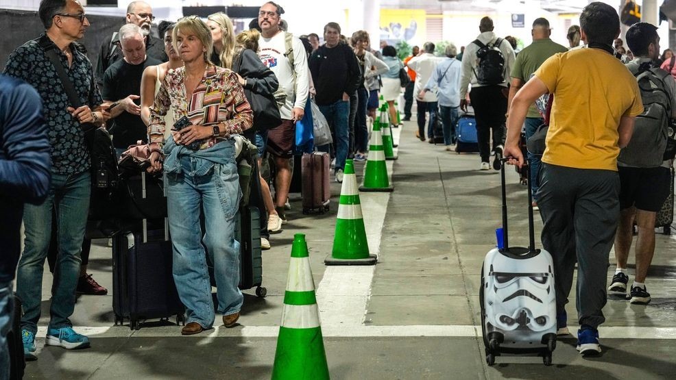 Airline passengers wait outside the terminal in the parking garage in long lines to get through the TSA security screening at William P. Hobby Airport in Houston, Sunday, March 8, 2026. (Brett Coomer/Houston Chronicle via AP)