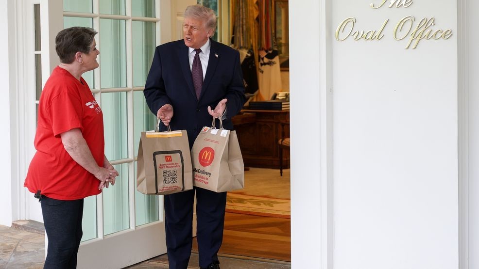 WASHINGTON, DC - APRIL 13: U.S. President Donald Trump receives a DoorDash delivery of McDonald's from Sharon Simmons before he speaks to the press during an event outside the Oval Office of the White House on April 13, 2026 in Washington, DC. The president spoke about the No Tax on Tips, Pope{ }Leo XIV and the ongoing negotiations with Iran. (Photo by Win McNamee/Getty Images)