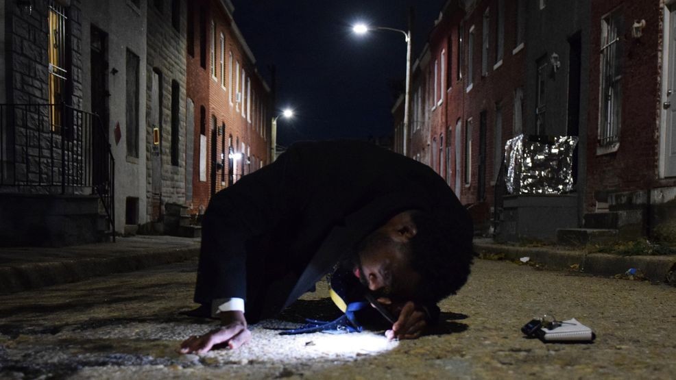 A homicide detective examines a spent cartridge casing near the site of a shooting that killed a man in East Baltimore on Tuesday, Nov. 4, 2025. (WBFF / Maggie Ybarra)