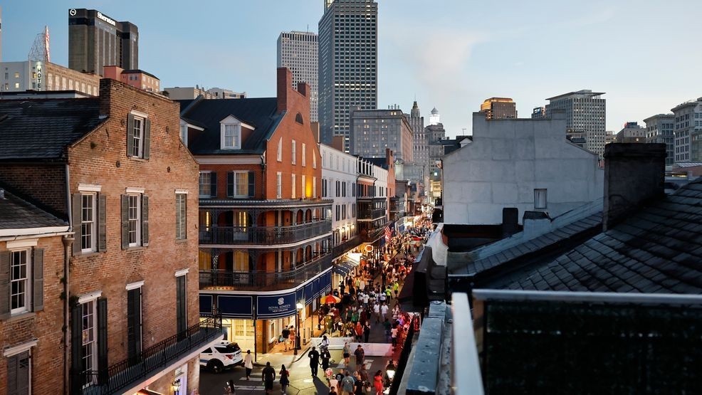 FILE - People walk on Bourbon Street in the French Quarter with the downtown skyline beyond on August 8, 2025, in New Orleans. (Photo by Mario Tama/Getty Images)