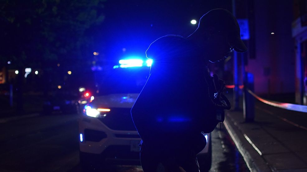 A crime lab technician searches for evidence of a shooting in the 1000 block of East Lombard Street on Thursday. (WBFF / Maggie Ybarra)