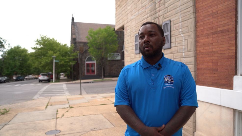 Robert "Bobby" Williams, owner of Baltimore-based Cutting Edge Construction and New Jack Property Management and Maintenance, outside one of his houses in East Baltimore that was taken over by squatters. (Zackary Lang/Spotlight on Maryland)