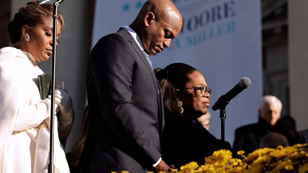 ANNAPOLIS, MARYLAND - JANUARY 18: Maryland Governor Wes Moore (C), first lady Dawn Moore (L) and Oprah Winfrey bow their heads in prayer at the conclusion of his inaugural ceremony at the Maryland State House on January 18, 2023 in Annapolis, Maryland. Democrat Moore defeated Republican nominee Dan Cox to become the first Black governor of Maryland and only the third Black person to be elected governor in the United States. (Photo by Chip Somodevilla/Getty Images)