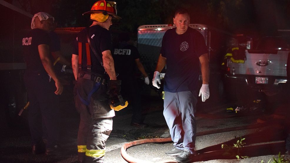 Firefighters use tools to access burned property behind the Patapsco Market on Thursday night. (WBFF / Maggie Ybarra)