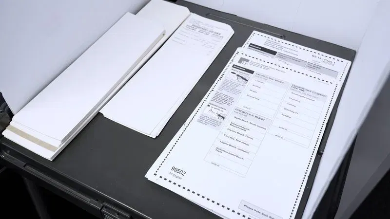 Test ballots printed by the Maryland State Board of Elections to sample new voting machines the agency is expecting to roll out by the 2028 elections. (Steve Pierce/Spotlight on Maryland)