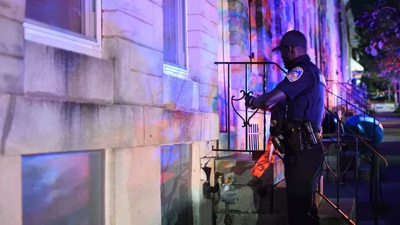 A Baltimore police officer establishes a crime scene in the 2500 block of West Fayette Street following a report of a shooting on Saturday morning. (WBFF / Maggie Ybarra)DSC_0776.JPG