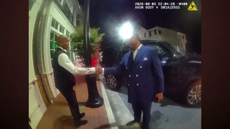 James Harrod, a Maryland State Police officer who also serves as the Maryland Senate's sergeant-at-arms, left, shakes hands with Maryland Del. C. Anthony Muse, D-Prince George's County, on Aug. 3, 2026, during an Annapolis police encounter involving the lawmaker hitting a stationary vehicle and then parking his car into a tree in Eastport. (Annapolis Police Department)