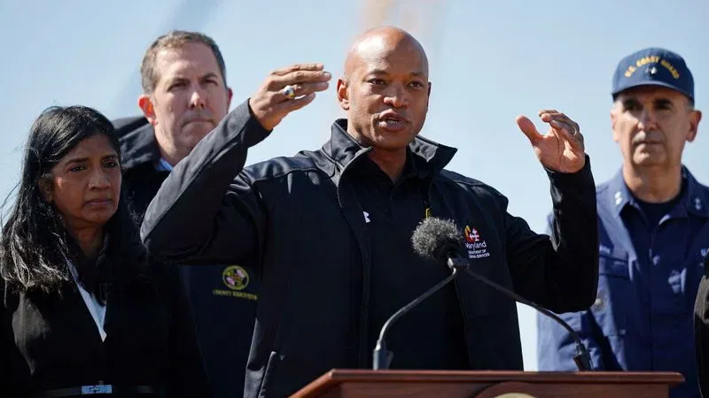 BALTIMORE, MARYLAND - MARCH 29: Maryland Gov. Wes Moore speaks during a news conference with (L-R) Lt. Gov. Aruna Miller, Baltimore County Executive Johnny Olszewski and U.S. Coast Guard Rear Adm. Shannon Gilreath about the ongoing response to the destruction of the Francis Scott Key Bridge on March 29, 2024 in Baltimore, Maryland. The bridge collapsed after being struck by the cargo ship Dali at 1:30AM on March 26. A road repair crew was on the bridge at the time, and two members were pulled from the water alive; two others have been found dead, and four remain missing and are presumed dead after the Coast Guard called off rescue efforts. The accident has temporarily closed the Port of Baltimore, one of the largest and busiest on the East Coast of the U.S.  (Photo by Chip Somodevilla/Getty Images)