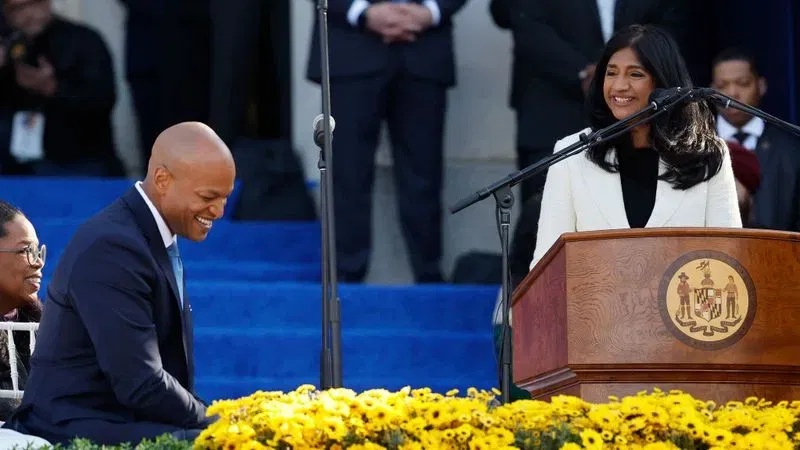ANNAPOLIS, MARYLAND - JANUARY 18: Maryland Governor Wes Moore (L) laughs as Lt. Governor Aruna Miller delivers her inaugural address at the Maryland State House on January 18, 2023 in Annapolis, Maryland. Miller made history as the first immigrant and first Asian American elected statewide in Maryland. Democrat Moore defeated Republican nominee Dan Cox to become the first Black governor of Maryland and only the third Black person to be elected governor in the United States. (Photo by Chip Somodevilla/Getty Images)