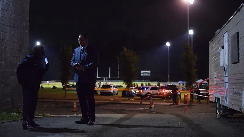 Northwestern District detectives discuss the parameters of an investigation into a shooting that injured three people and killed a 12-year-old girl at Leon Day Park on Oct. 3. (WBFF / Maggie Ybarra)