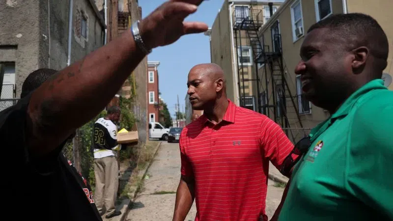 BALTIMORE, MARYLAND - SEPTEMBER 16: Maryland Democratic gubernatorial candidate Wes Moore talks with city residents after helping at a food distribution center at the Ruth Kirk Recreation Center September 16, 2022 in Baltimore, Maryland. Moore is running against Republican gubernatorial candidate Dan Cox. (Photo by Win McNamee/Getty Images)