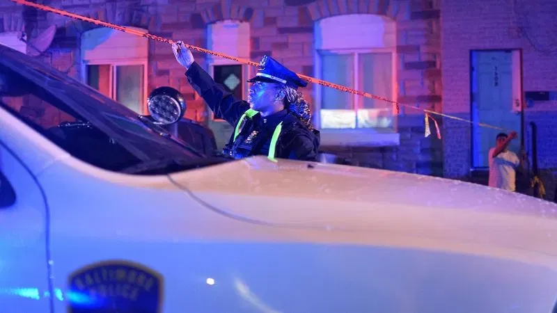 Residents of Baltimore Highlands assist police as they investigate a shooting in the 3500 block of East Lombard Street on Thursday morning. (WBFF / Maggie Ybarra)