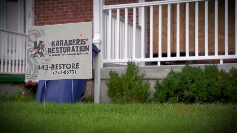 A fire restoration sign at a home in Baltimore undergoing post-fire renovation. (Zackary Lang/Spotlight on Maryland)